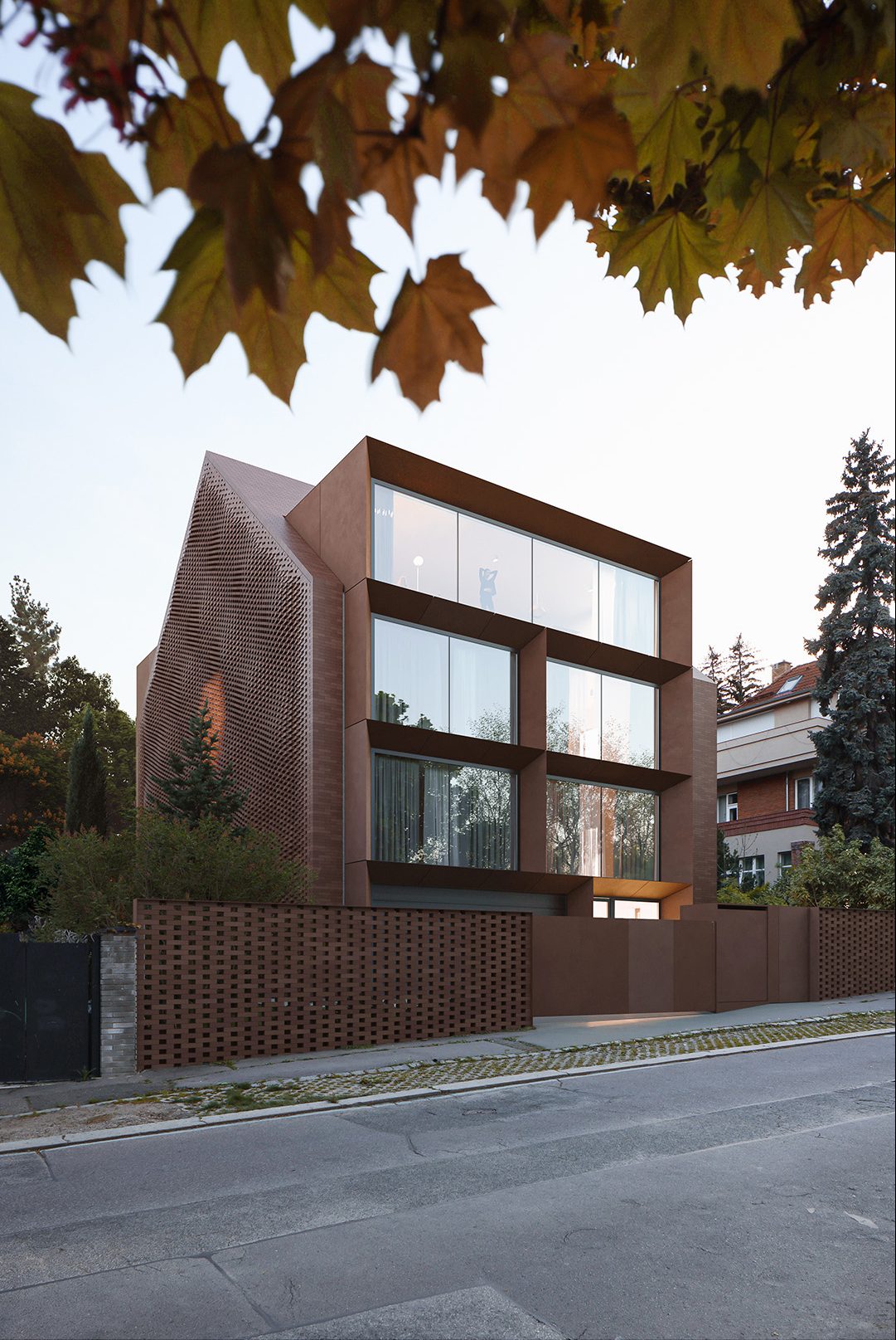 This project started with a sketch, drawn by hand, and a vision of a unique brick facade.  The result is this stunning family home in a quiet part of the Dejvice neighborhood of Prague.  Evening light and a muted autumnal atmosphere help paint a picture of a family abode that combines bold design with discreet street presence.